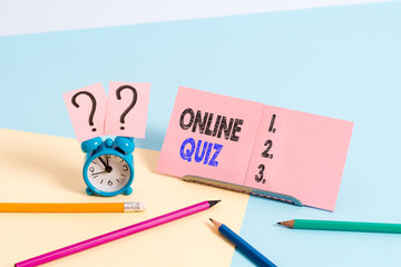 Conceptual hand writing showing Online Quiz. Concept meaning game or a mind sport that are published on the Internet Mini size alarm clock beside stationary on pastel backdrop