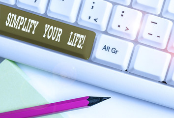 Text sign showing Simplify Your Life. Business photo showcasing focused on important and let someone else worry about less ones White pc keyboard with empty note paper above white background key copy