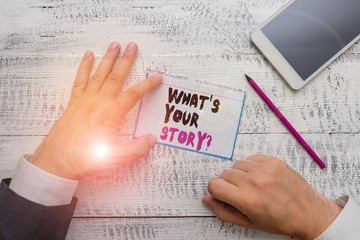 Fototapeta premium Conceptual hand writing showing What S Is Your Story question. Concept meaning being asked by someone about my own journey from beginning till now Hand hold note paper near writing equipment and