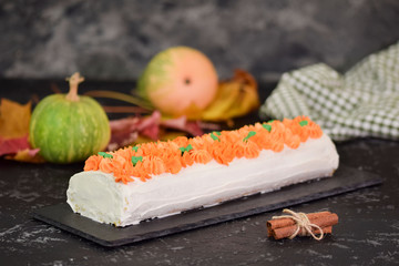 Fall dessert pumpkin roll with cream cheese. Bakery, frosting.