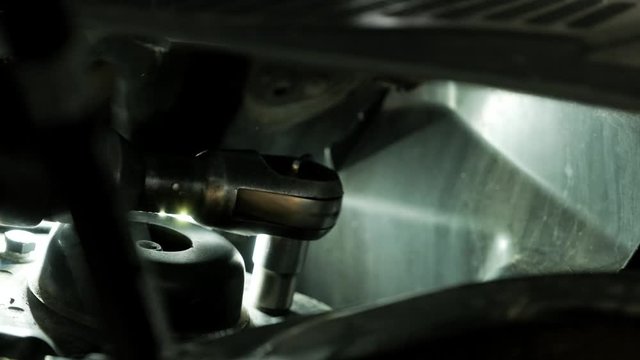 Auto mechanic repair under carin the car  repair shop. Close up