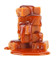 Sweet caramel candies with caramel topping isolated on a white background