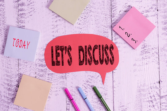 Text sign showing Let S Discuss. Business photo text asking someone to talk about something with demonstrating or showing Ballpoints pens blank colored speech bubble sticky notes wooden background