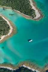 Fototapeta na wymiar Aerial view of sea and beach in a lagoon on Cres ( isola Cherso ) Island Croatia, close to Punta Kriza ( Punta Croce ). It is a part of national where rocks and sand and forest merge on a coast. 