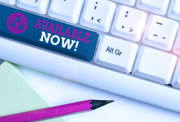 Conceptual hand writing showing Available Now. Concept meaning you can find it obtain or operable at this current moment White pc keyboard with note paper above the white background