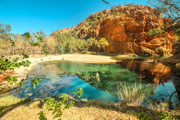 Aerial view of Ellery Creek Big Hole waterhole fed by West MacDonnell Ranges and surrounded by red cliffs. Starting point for Sections 6 and 7 of Larapinta Trail walk in Northern Territory, Australia.