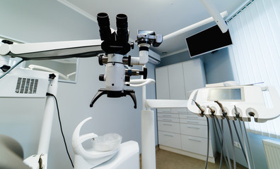 Brand new medical office. Dentist room. Stomatologist professional equipment. Hi tech medical clinic. Dentist clinic. Modern dental office interior. Advanced Microscope for teeth treatment.