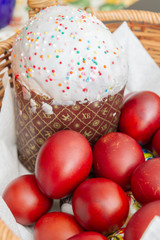 Easter spring cake with painted chicken eggs in a wicker basket
