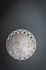 Easter spring cake in white glaze with colored sprinkles