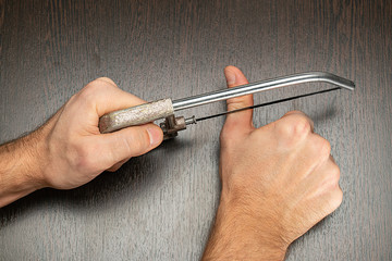Cutting the thumb with a saw, closeup