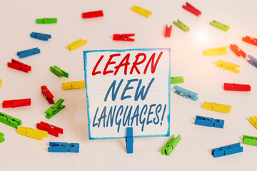Handwriting text Learn New Languages. Conceptual photo developing ability to communicate in foreign lang Colored clothespin papers empty reminder white floor background office
