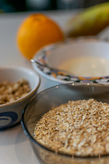 Close-up of a bowl of oatmeal, with granola, yoghurt and fresh fruit. Ingredients for a healthy breakfast.
