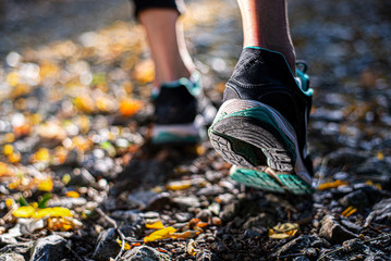 Closeup of footwear of a female runner getting ready for a trail run