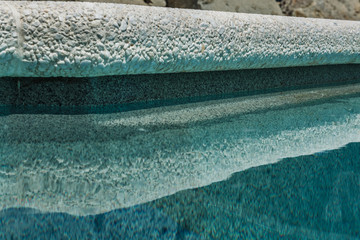 A natural stone. Facing tiles. Paving slabs. Granite. Marble. Crushed stone Texture. Terrace. The territory near the pool. Material. Limestone.