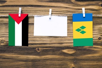 Hanging flags of Palestine and Saint Vincent And The Grenadines attached to rope with clothes pins...