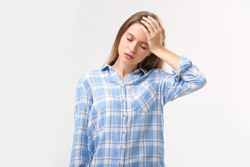 Stressed young woman on white background