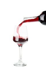 Pouring of wine into glass on white background