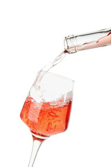 Pouring of wine into glass on white background