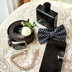different accessories of a businessman for creating a style of a people lie on a wooden background