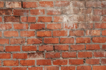 Old red brick wall in Italy. Faded red color, a bit dirty. Copy space for text