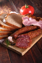 meat and sausages on wooden board