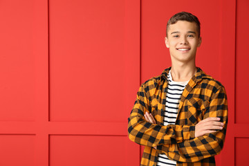 Cool teenage boy on color background