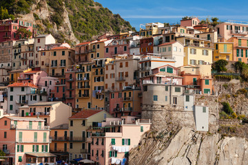 Fototapeta na wymiar Italy, Liguria region, Cinque Terre national resort - dream destination for tourists. Colorful houses, bright blue sky. Summer, vacations time.
