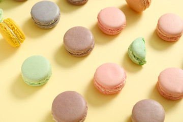 Tasty macarons on color background