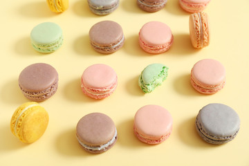 Tasty macarons on color background