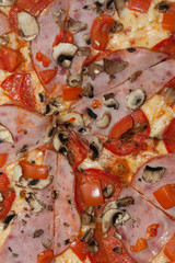 Cured parma ham on a Traditional Italian pizza with mozzarella cheese and tomato on a thick pastry...