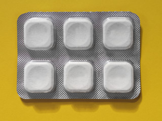 Blister with six white tablets or pills. Abstract photo on the subject of medicine, pharmacy,...