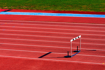 TRACK WITH ATHLETIC JUMP FENCE. SPORTS PHOTOGRAPH.