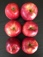 Juicy red apples on the black background