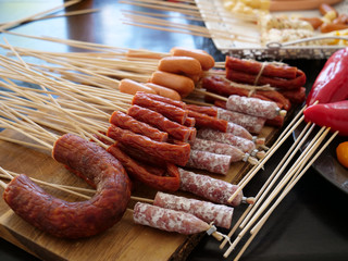sausages on sticks on a talbe