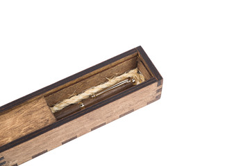 Beautiful wooden box with ballpoint pen inside on a white background.