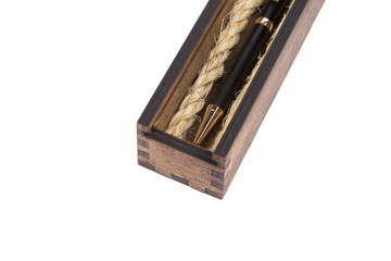 Beautiful wooden box with ballpoint pen inside on a white background.