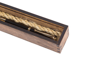 Beautiful wooden box with ballpoint pen inside on a white background.