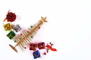 Small Christmas tree with star and various colorful gifts on white background. Christmas concept.