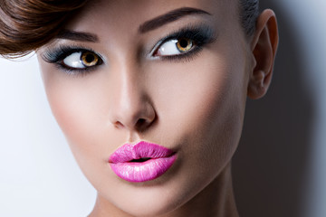 Portrait of a pretty girl model with pink lipstick looking away