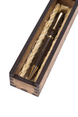 Beautiful wooden box with ballpoint pen inside on a white background.