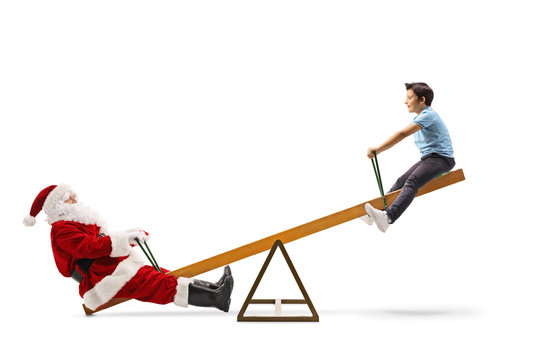 Santa Claus Playing On A Seesaw With A Boy And Laughing