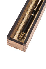Beautiful wooden box with ballpoint pen inside on a white background.