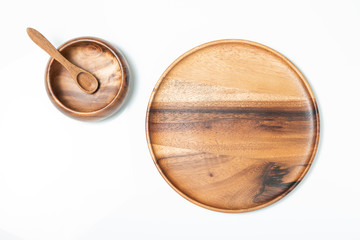 Empty wooden bowl, spoon and plate, top view.