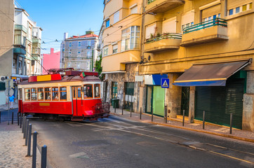 Fototapeta na wymiar Famous vintage tram in the street of Alfama, Lisbon, Portugal