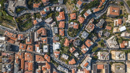 Overhead aerial view of red orange houses and trees in La Spezia in Italy