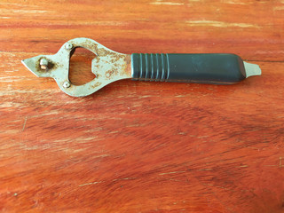  The bottle opener is rusty on wood background