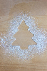 Christmas tree form sprinkled with flour on the table