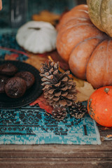 Beautiful autumn composition with pumpkin, box, leaves, cone and waffles