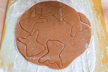 Christmas shaped gingerbread cookie from the raw dough before baking