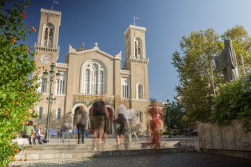 Walk in historic neighbourhood Plaka of Athens, Greece on a beautiful autumn afternoon. Cathedral in the background.
